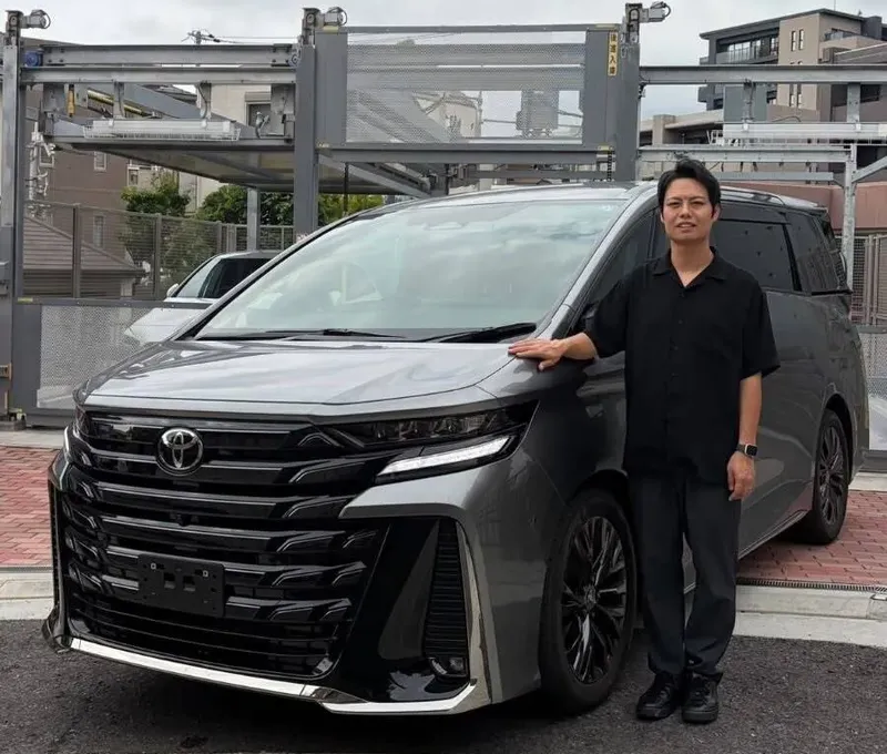 輸出する車の前に立つ代表の谷口